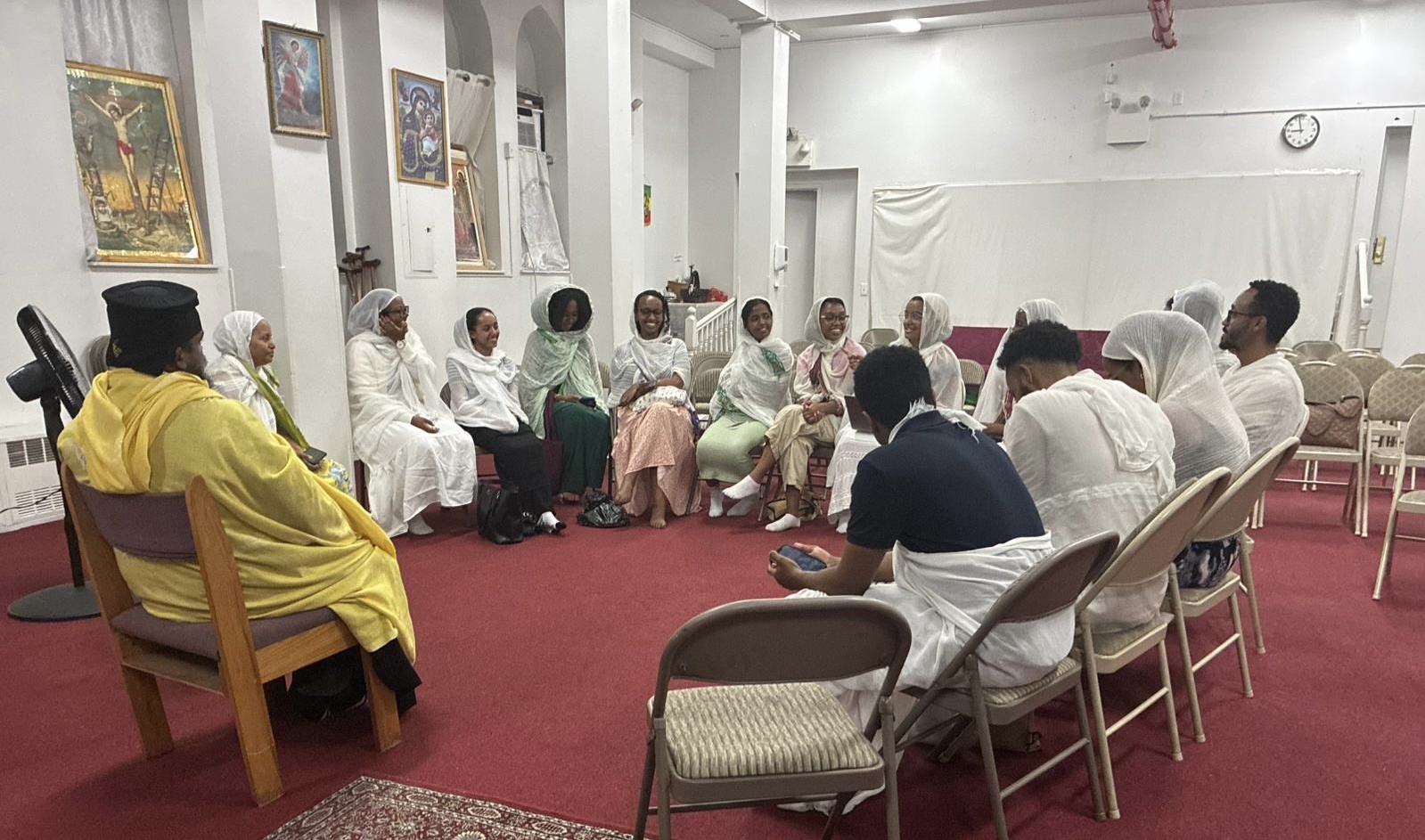 Abba Ephrem leads a fellowship discussion with OTY NYC members seated in a circle