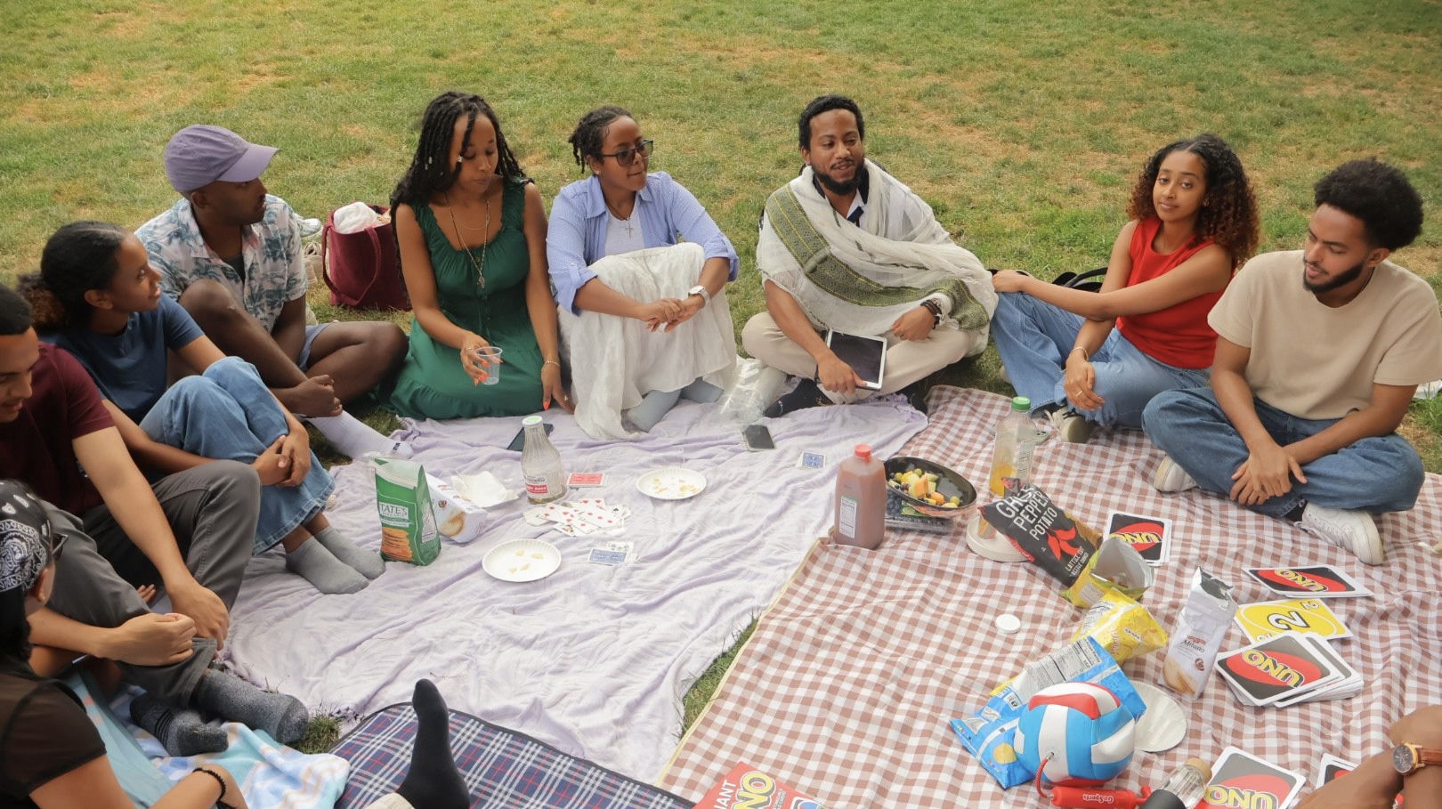 OTY NYC members share a picnic and games with Deacon Christian in the park